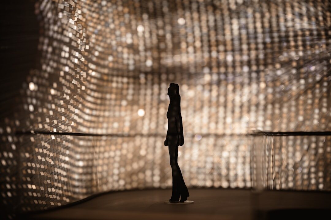 Fashion runway show with model walking under bright lights