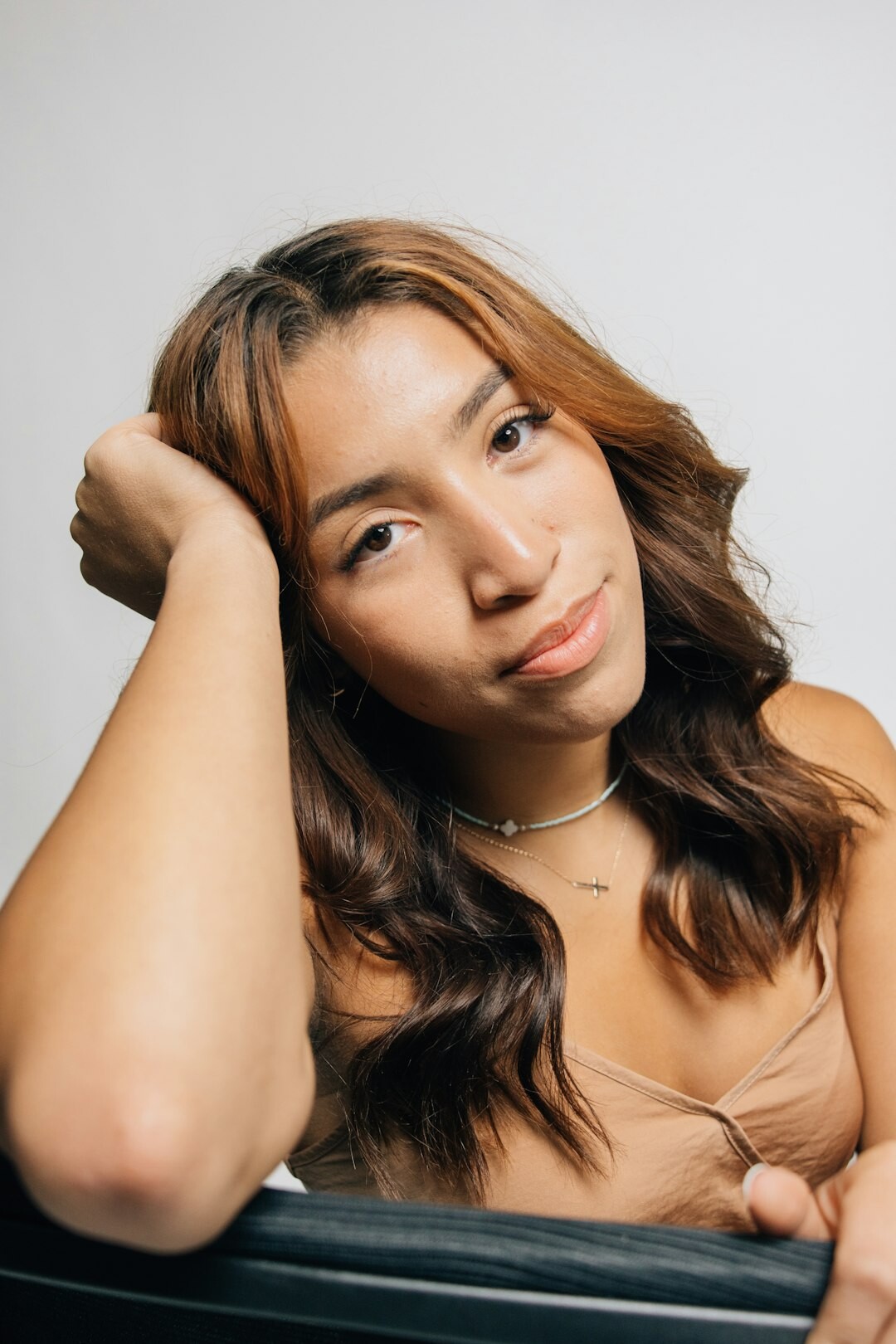 Studio portrait of a young Latina woman smiling confidently